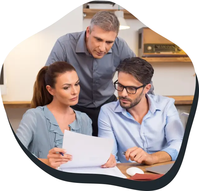 Three colleagues reviewing a document together